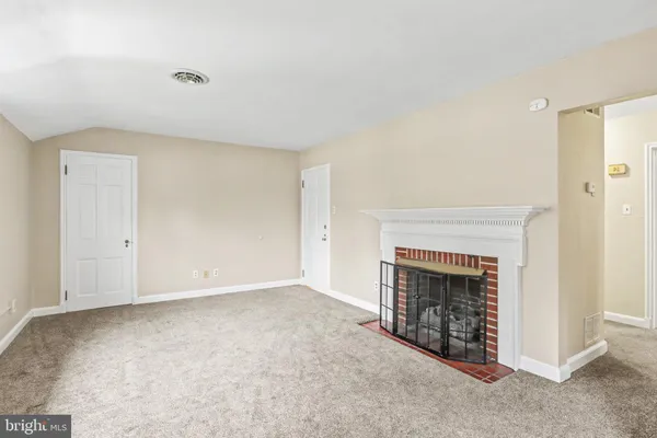 a view of empty room with a fireplace
