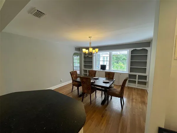 a view of a dining room with furniture and wooden floor
