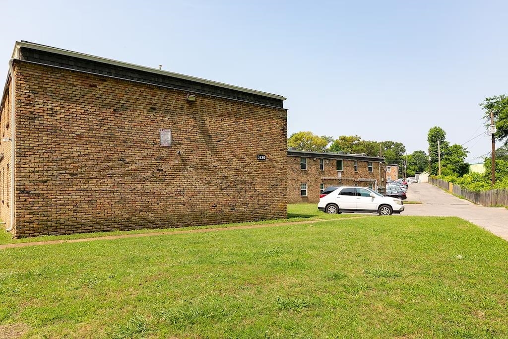 3236 Millington Road Memphis, TN 38127 - Photo 27 of 31 Brick exterior apartment building with a flat roofline, featuring individual window openings