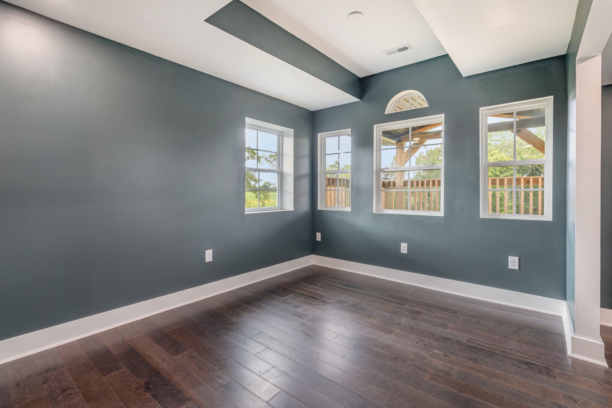 5837 Rocky Mound Road Westmoreland, TN 37186 - Photo 17 of 41 an empty room with wooden floor and windows