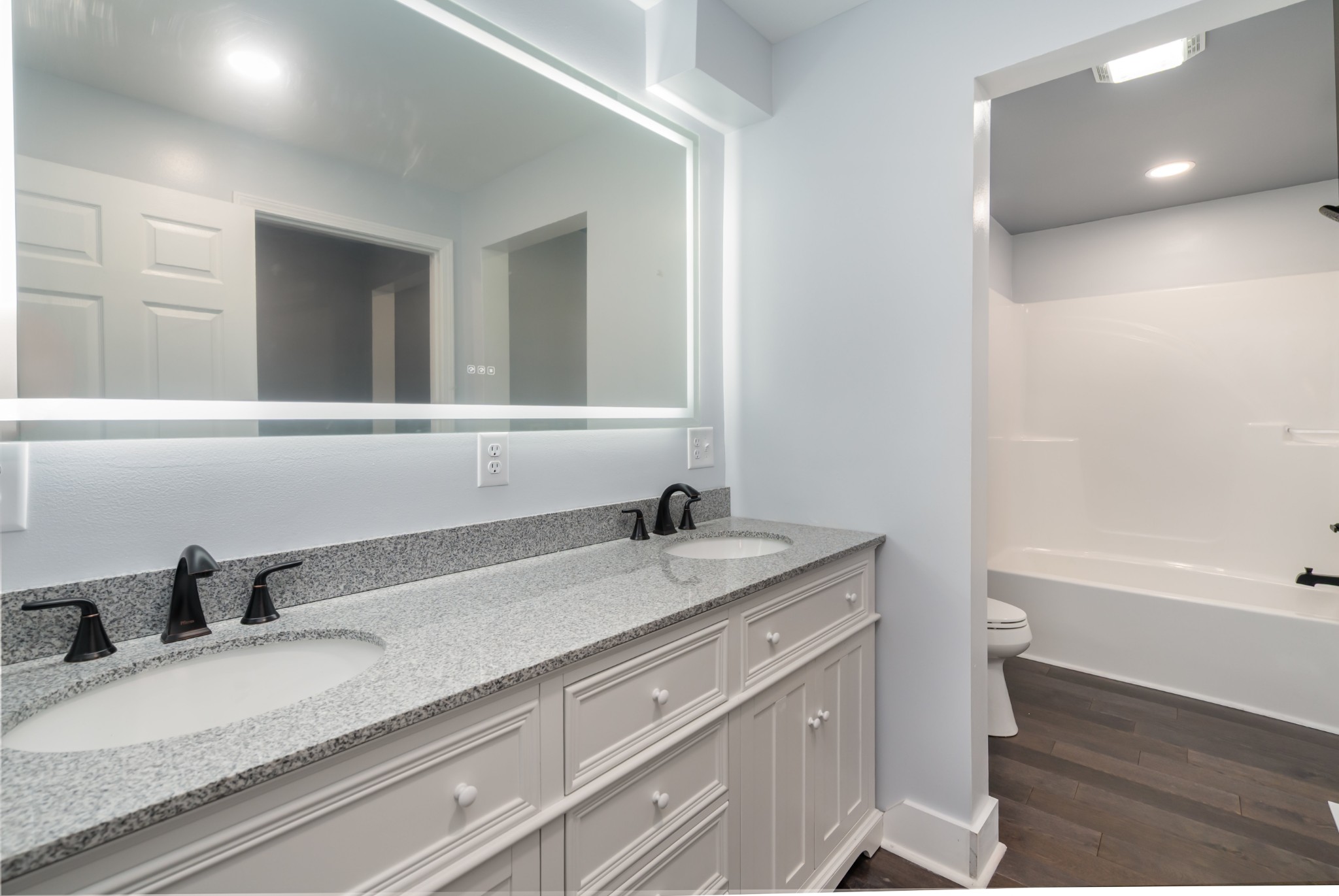 5837 Rocky Mound Road Westmoreland, TN 37186 - Photo 23 of 41 a bathroom with a granite countertop sink a toilet and bathtub