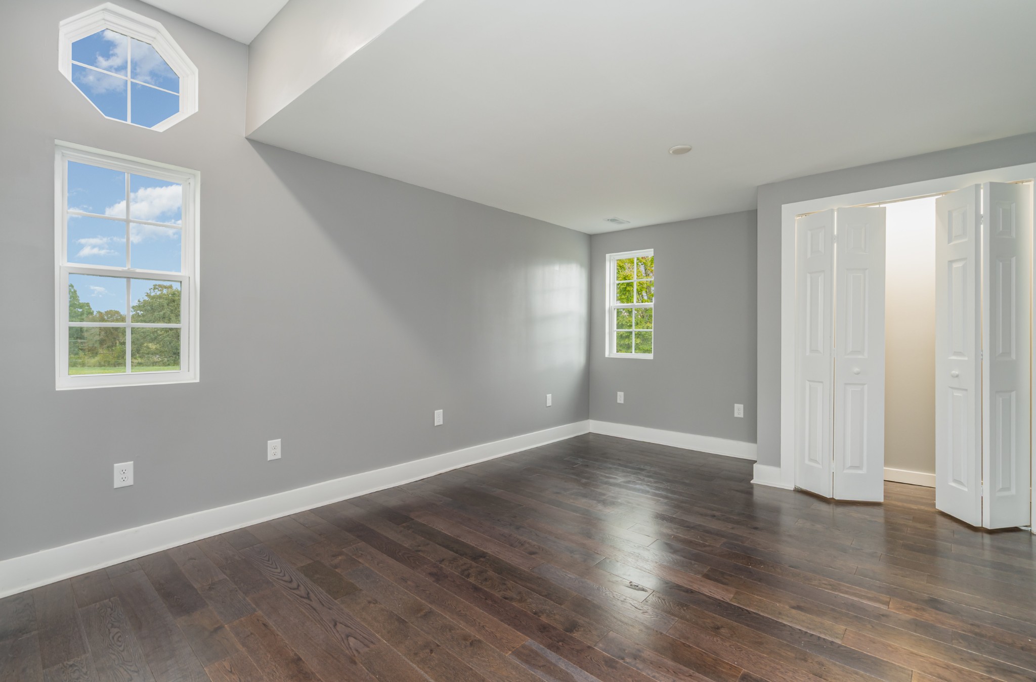 5837 Rocky Mound Road Westmoreland, TN 37186 - Photo 26 of 41 an empty room with wooden floor and windows