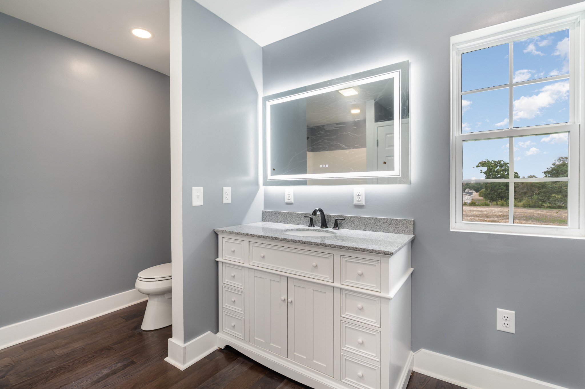 5837 Rocky Mound Road Westmoreland, TN 37186 - Photo 28 of 41 a view of bathroom with a toilet sink and mirror