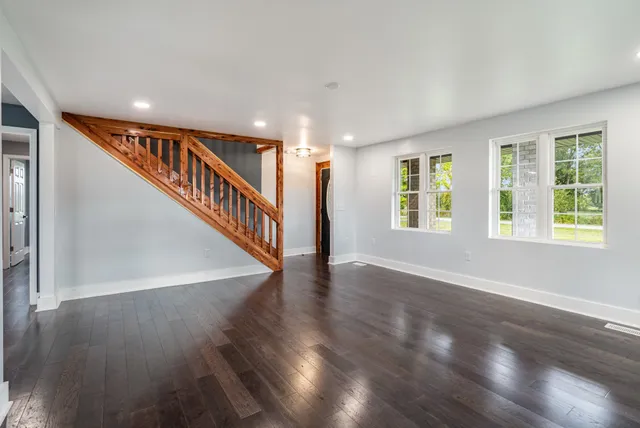 a view of an entryway with wooden floor