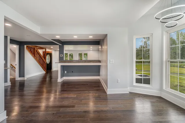 a view of entryway and hall with wooden floor