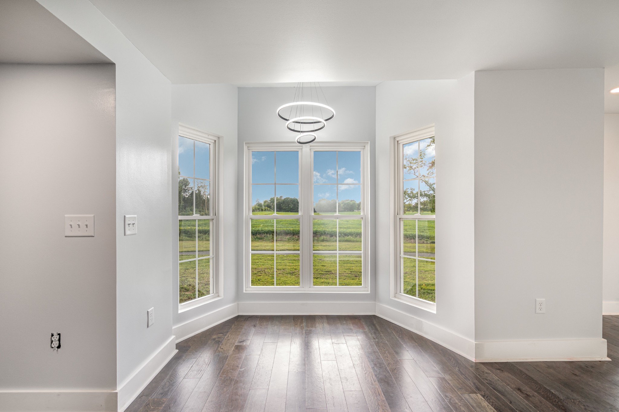 5837 Rocky Mound Road Westmoreland, TN 37186 - Photo 10 of 41 an empty room with wooden floor and windows