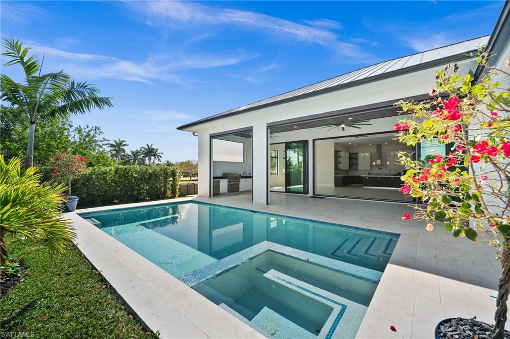 1045 Morningside Drive Naples, FL 34103 - Photo 29 of 50 View of swimming pool featuring exterior kitchen, a patio, a pool with connected hot tub, and ceiling fan