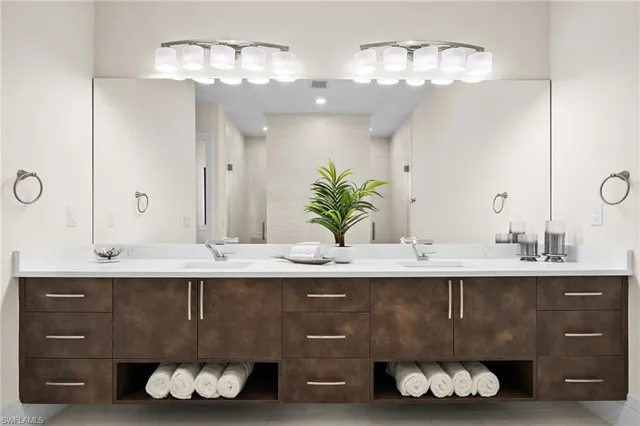 a spacious bathroom with a double vanity sink and a mirror