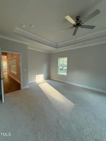 a view of a livingroom with a ceiling fan and window