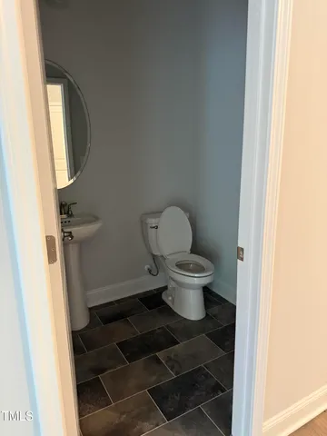 a view of a room with wooden floor and windows