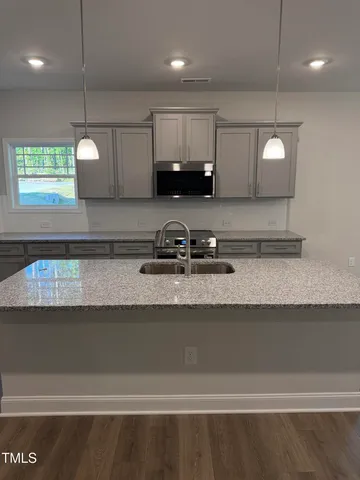 a kitchen with a sink a counter space and cabinets