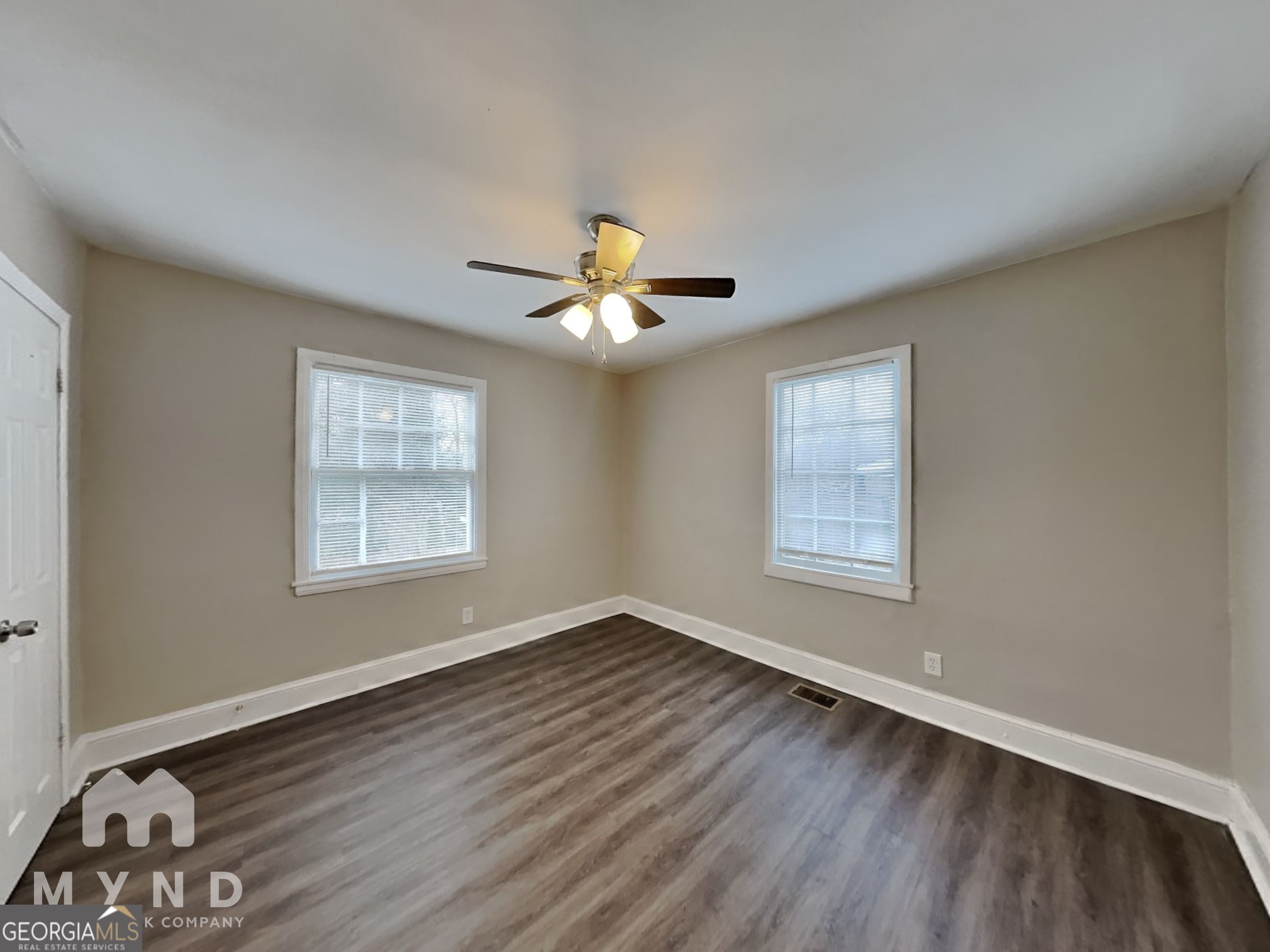 1284 Westmont Road Southwest Atlanta, GA 30311 - Photo 14 of 20 a view of an empty room with wooden floor and a window