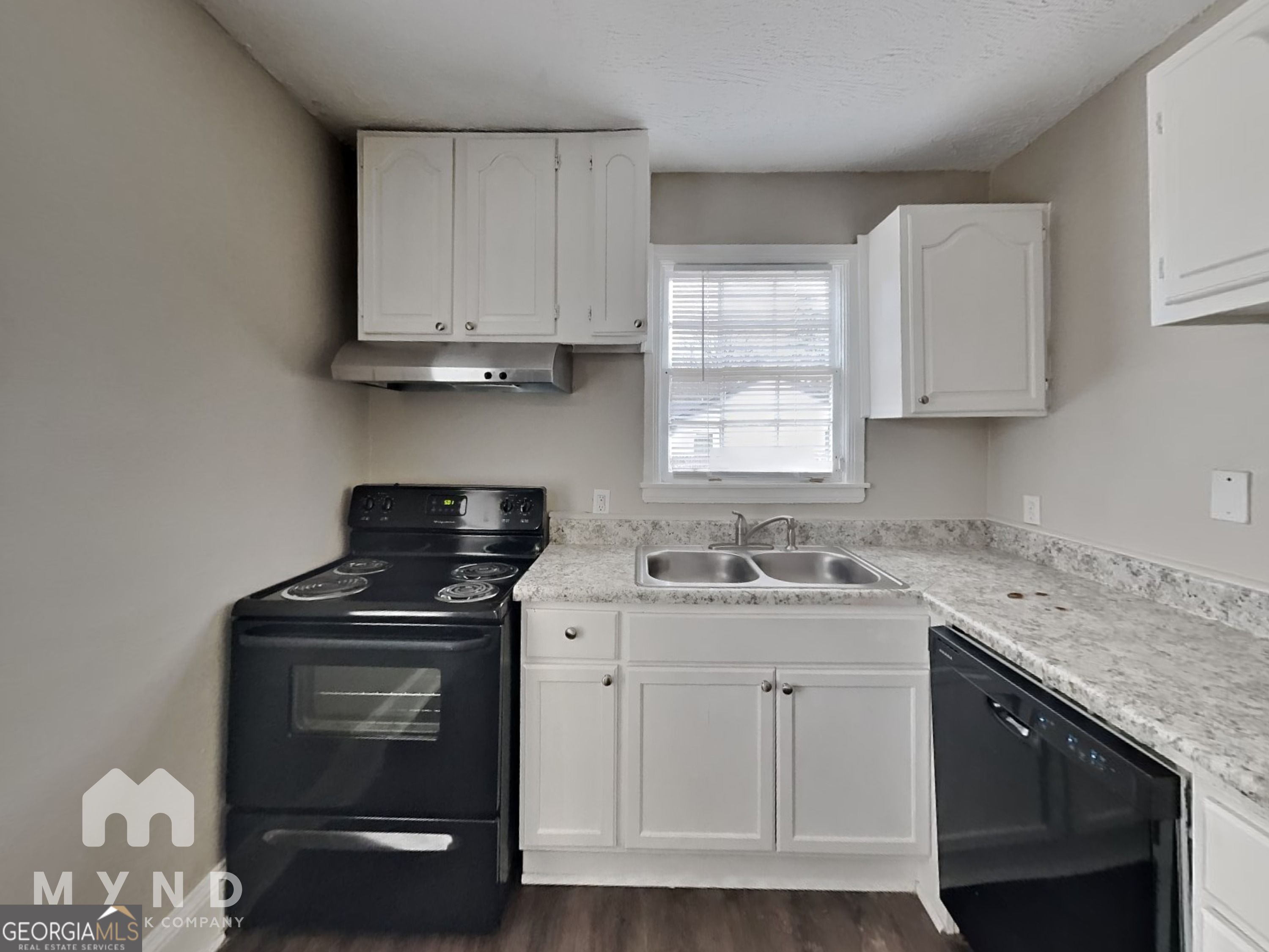 1284 Westmont Road Southwest Atlanta, GA 30311 - Photo 4 of 20 a kitchen with cabinets appliances a sink and a window