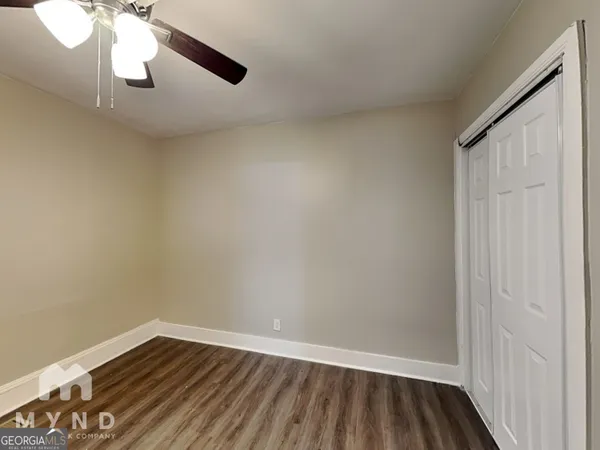 a view of an empty room and wooden floor