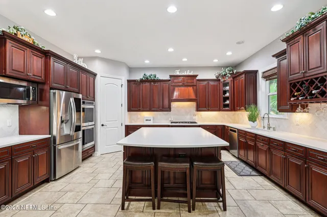 a kitchen with a stove a sink dishwasher and a refrigerator with wooden cabinets