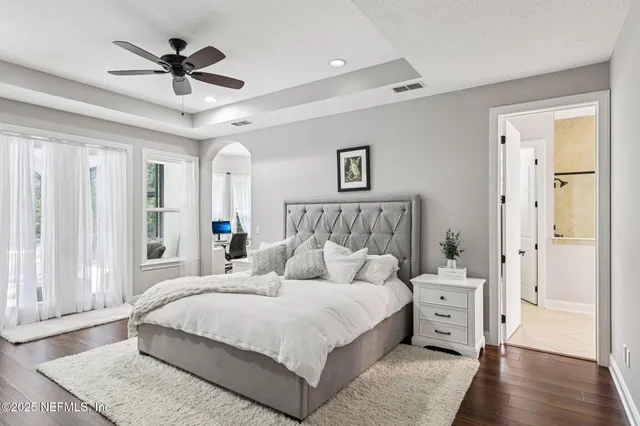 a large white tub sitting in a bathroom next to a window