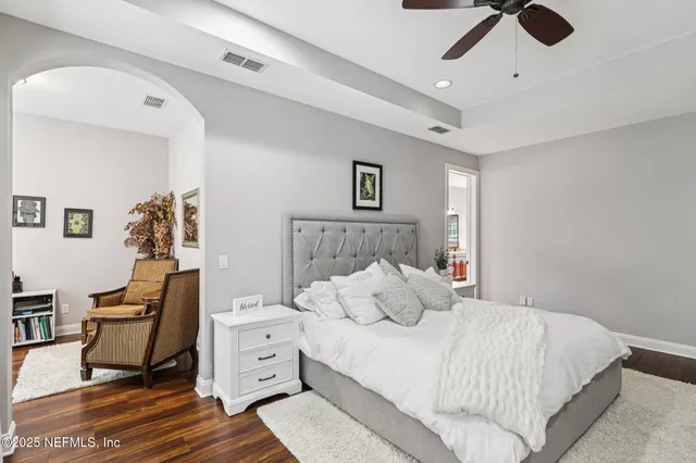a bedroom with a bed and a potted plant