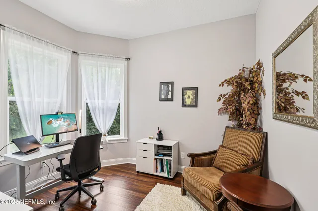 a bathroom with a granite countertop sink toilet a mirror and shower