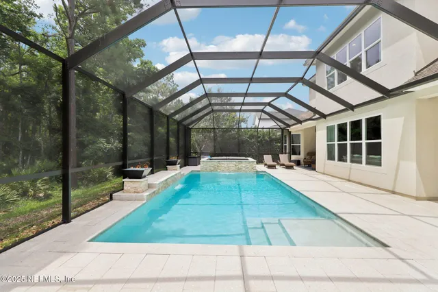 a view of swimming pool with a table and chairs