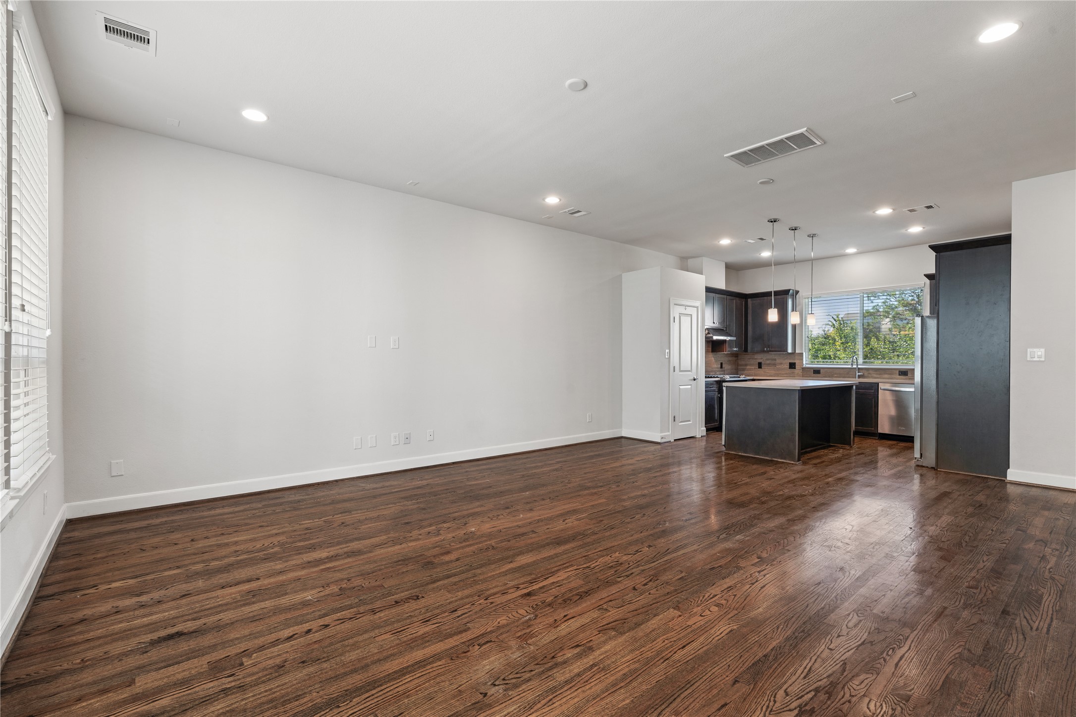 1013 West 17th Street Houston, TX 77008 - Photo 11 of 26 a view of kitchen with kitchen island wooden floor center island and stainless steel appliances
