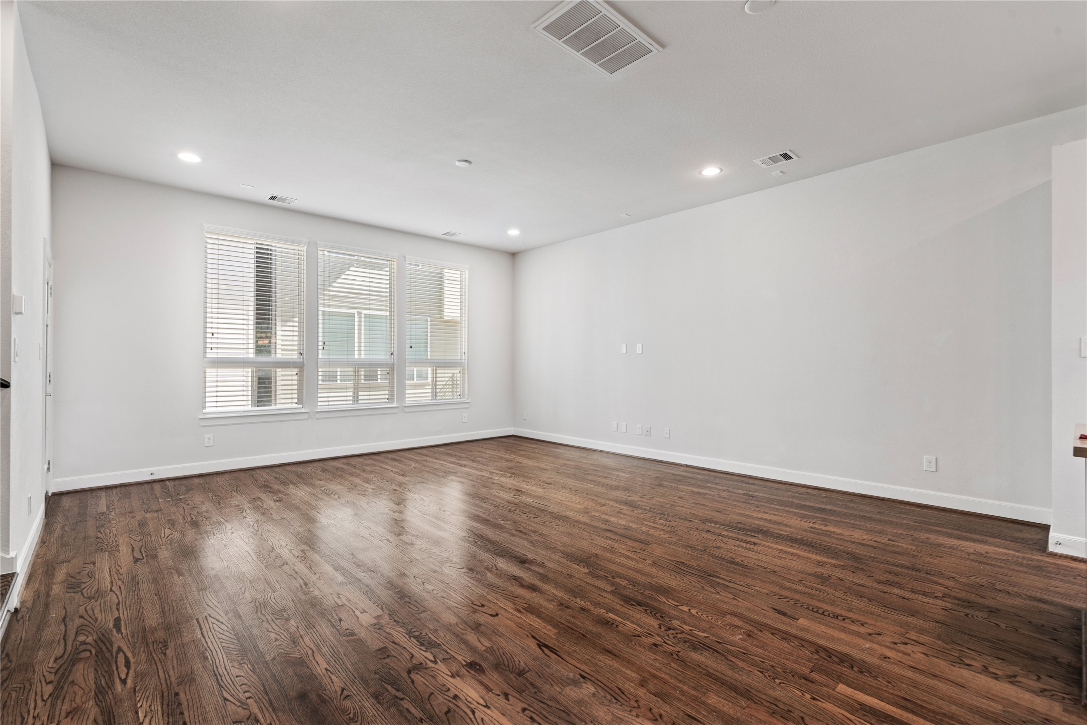 1013 West 17th Street Houston, TX 77008 - Photo 13 of 26 a view of an empty room with wooden floor and a window