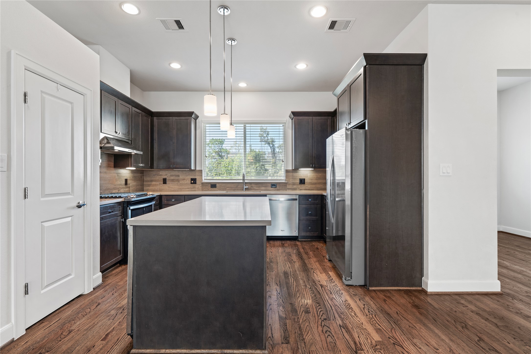 1013 West 17th Street Houston, TX 77008 - Photo 7 of 26 a kitchen with stainless steel appliances a refrigerator stove microwave and cabinets
