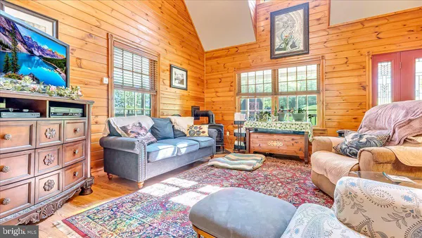 a living room with furniture fireplace and a large window