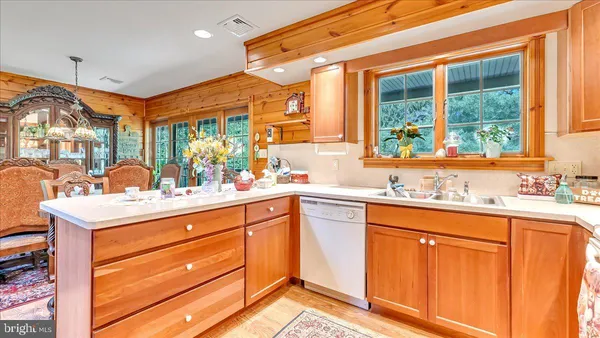 a kitchen with sink cabinets and chandelier