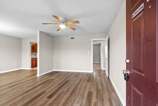 wooden floor in an empty room with a window