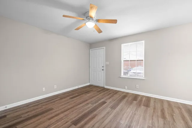 wooden floor in an empty room with a window