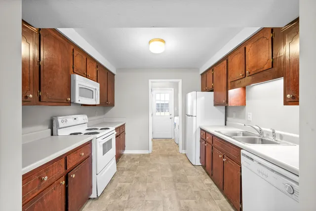 a kitchen with stainless steel appliances granite countertop a sink stove and cabinets