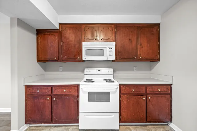 a kitchen with a stove and cabinets