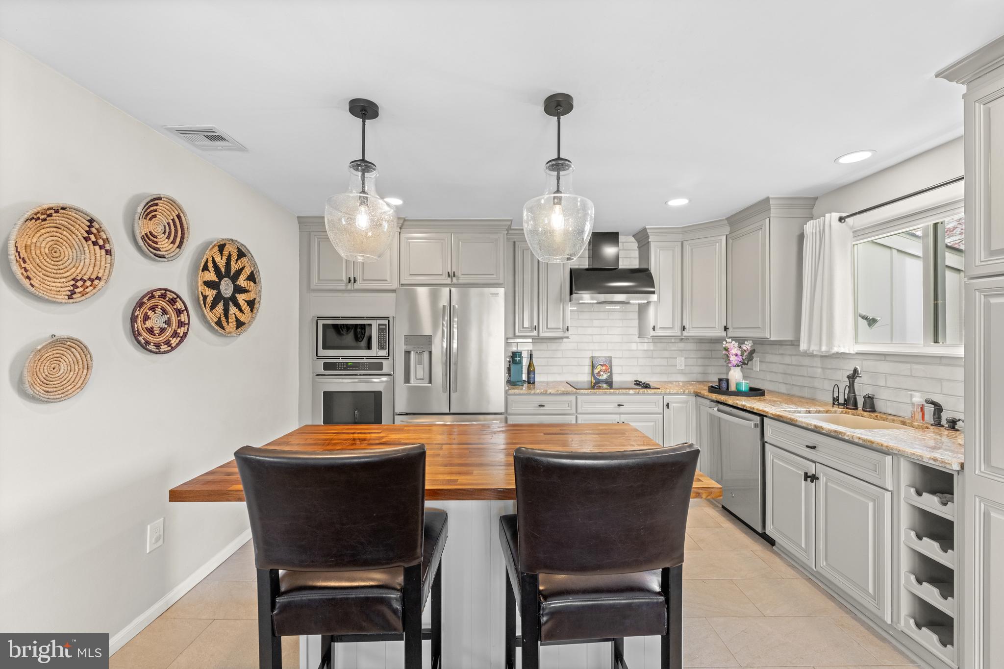 221 Hemlock Lane Springfield, PA 19064 - Photo 15 of 36 a large kitchen with a table and chairs