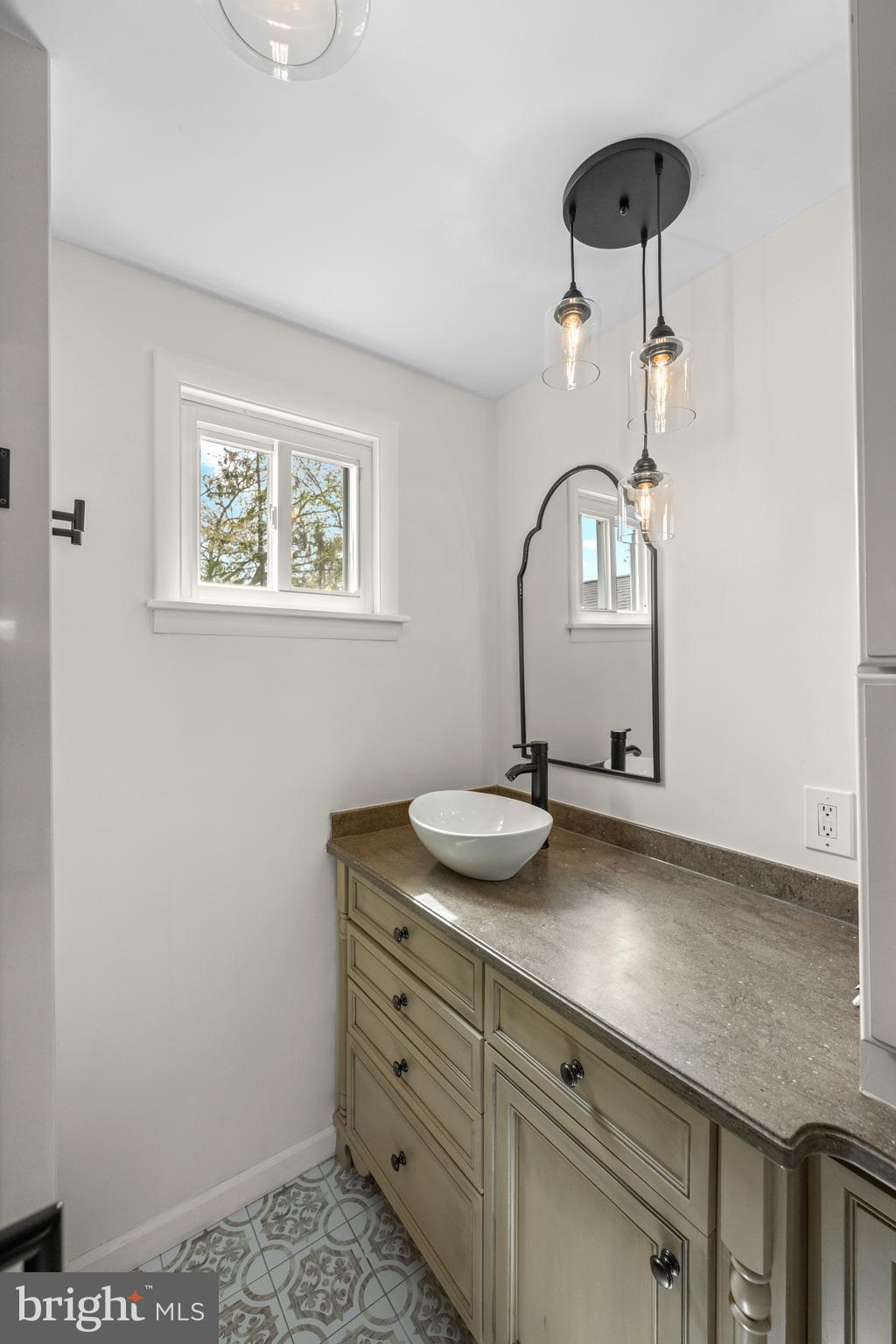 221 Hemlock Lane Springfield, PA 19064 - Photo 27 of 36 a bathroom with a sink and a mirror