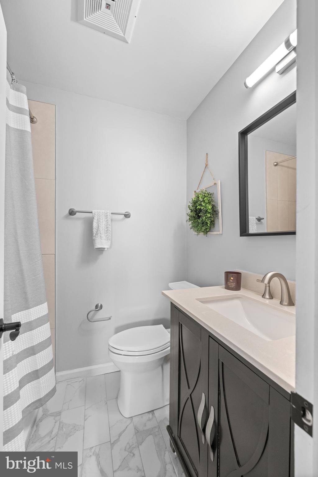221 Hemlock Lane Springfield, PA 19064 - Photo 31 of 36 a bathroom with a sink toilet and mirror