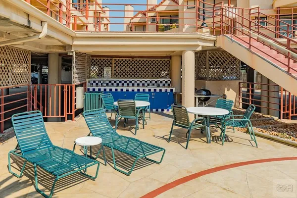 a view of a chairs and table in a patio