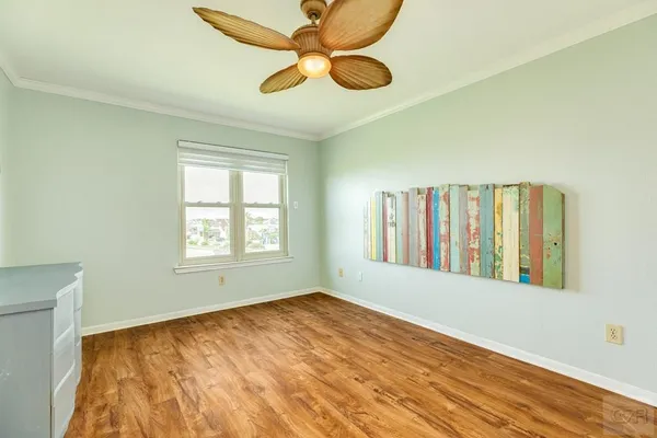 a view of an empty room with window and cabinet
