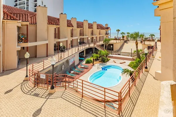 a view of a swimming pool with outdoor seating and city view