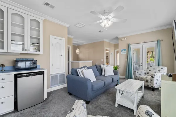 a living room with furniture and a chandelier