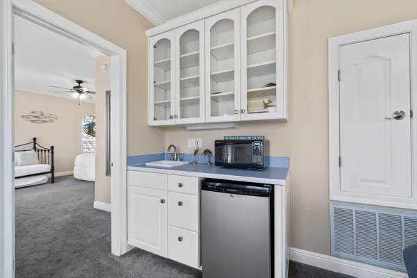 a bedroom with a bed a dresser and large mirror