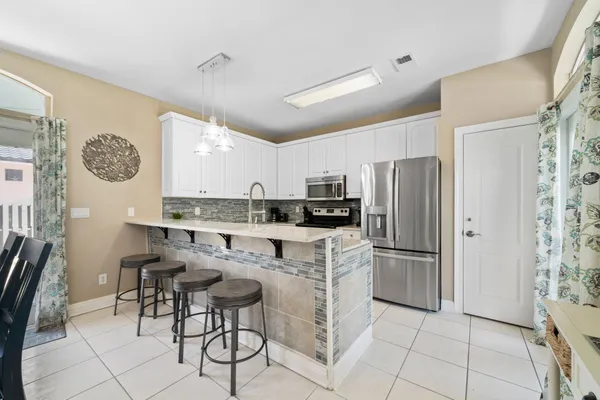 a kitchen with a sink stove and refrigerator