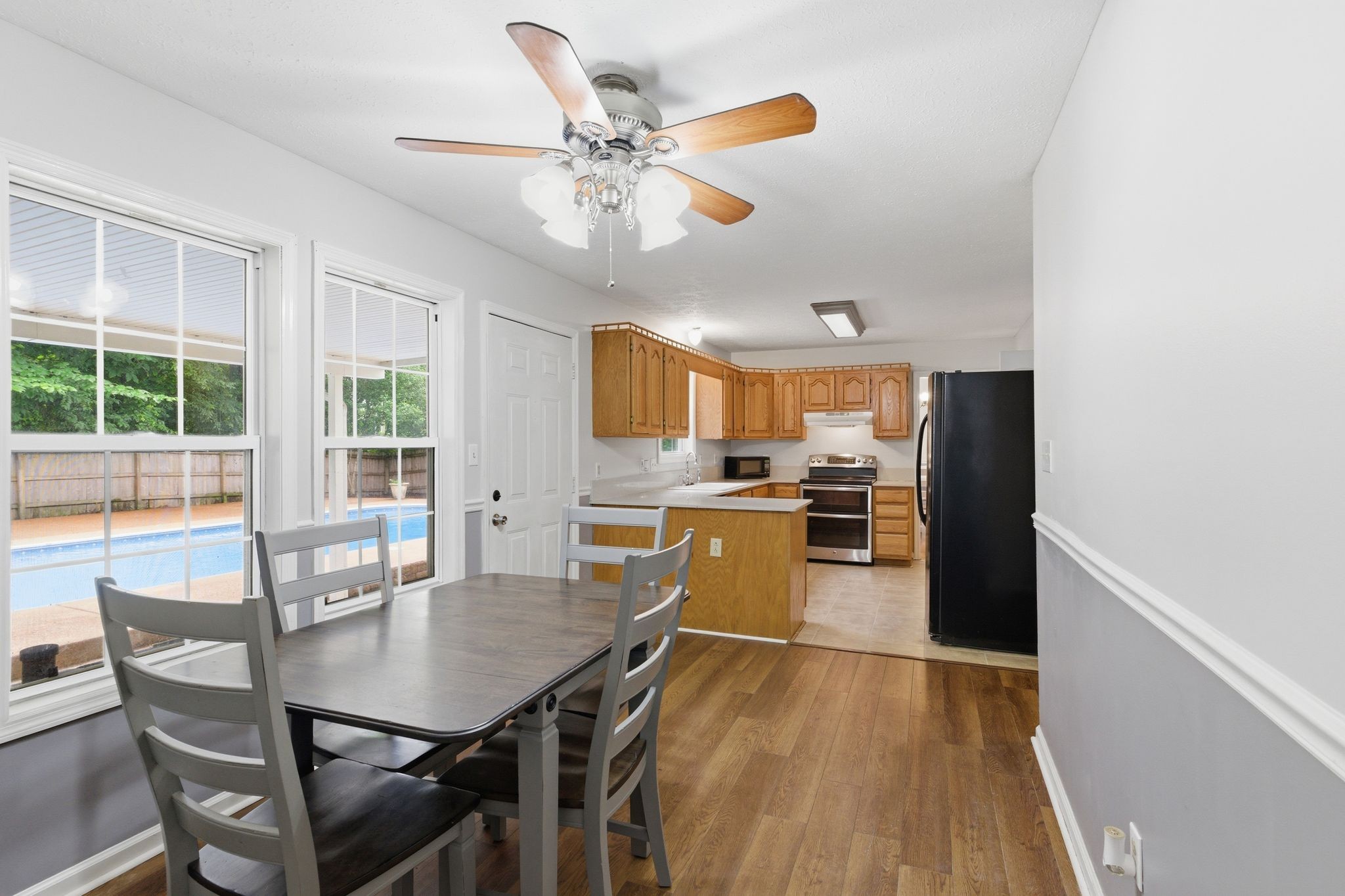 615 Vaughan's Gap Road Spring Hill, TN 37174 - Photo 13 of 26 a kitchen with a table chairs and refrigerator