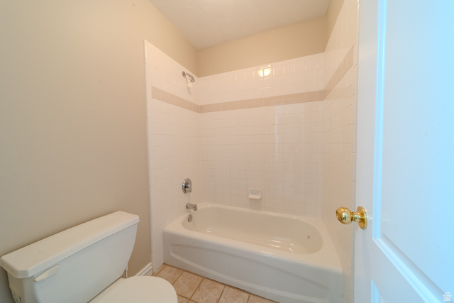 598 Hollow Creek Road Draper, UT 84020 - Photo 81 of 110 Bathroom featuring a white bathtub with chrome fixtures, white subway tile surround, and a decorative tile accent band