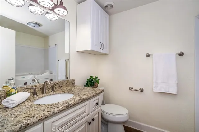 a view of a terrace with couches and wooden fence