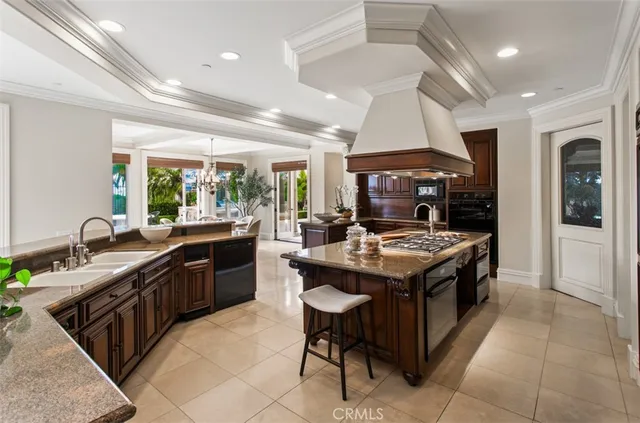 a kitchen with stainless steel appliances granite countertop a sink dishwasher stove and refrigerator