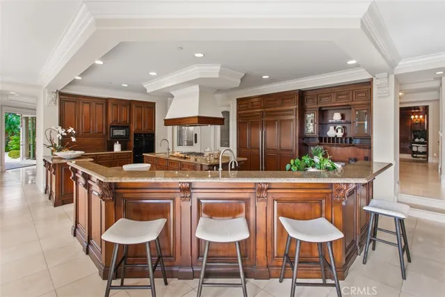 a living room with furniture and a view of kitchen