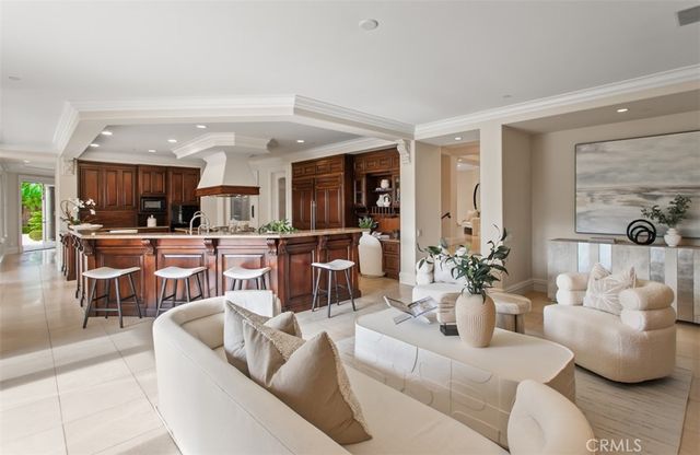 a dining room with furniture a chandelier and wooden floor