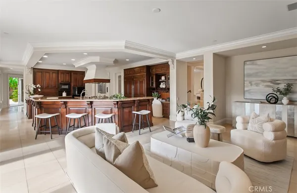 a dining room with furniture a chandelier and wooden floor