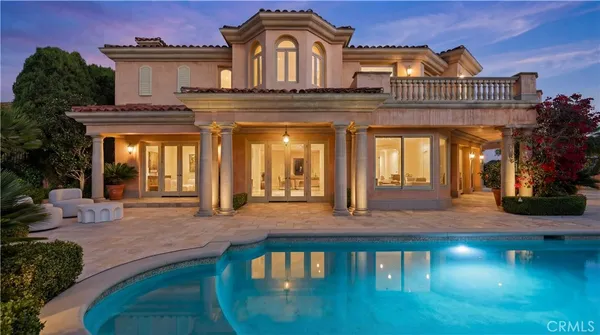 a view of a house with a chairs in patio