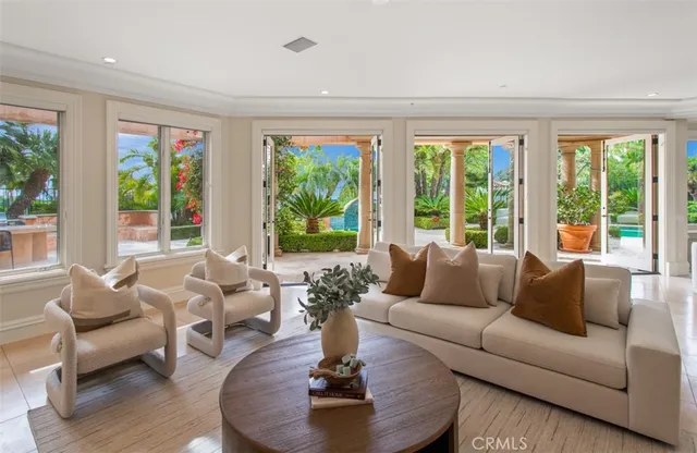 a living room with furniture fireplace and a large window